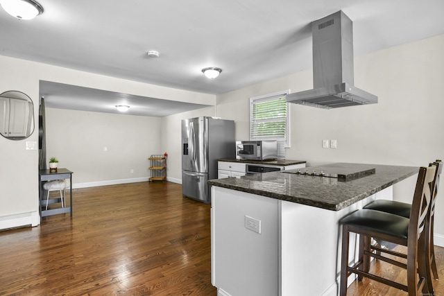 198 Macon Dr, Bridgeport, CT 06606 - kitchen featuring appliances with stainless steel finishes, island range hood, dark wood-style flooring, a kitchen breakfast bar, and dark stone counters