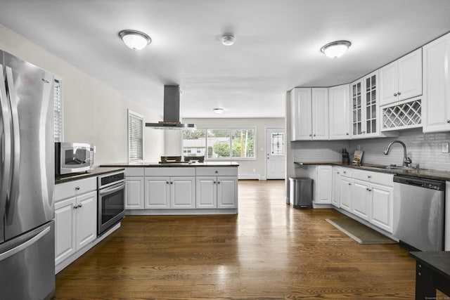198 Macon Dr, Bridgeport, CT 06606 - kitchen with stainless steel appliances, wall chimney exhaust hood, dark countertops, glass insert cabinets, and dark wood finished floors