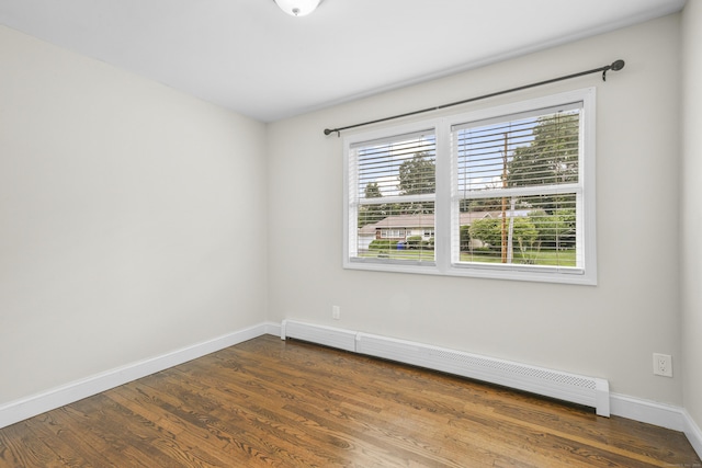 198 Macon Dr, Bridgeport, CT 06606 - spare room featuring a baseboard heating unit and dark wood-style flooring