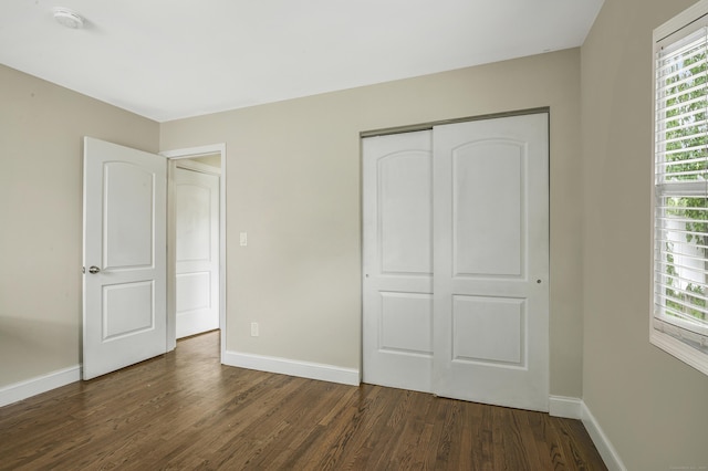 198 Macon Dr, Bridgeport, CT 06606 - unfurnished bedroom with dark wood-type flooring and a closet