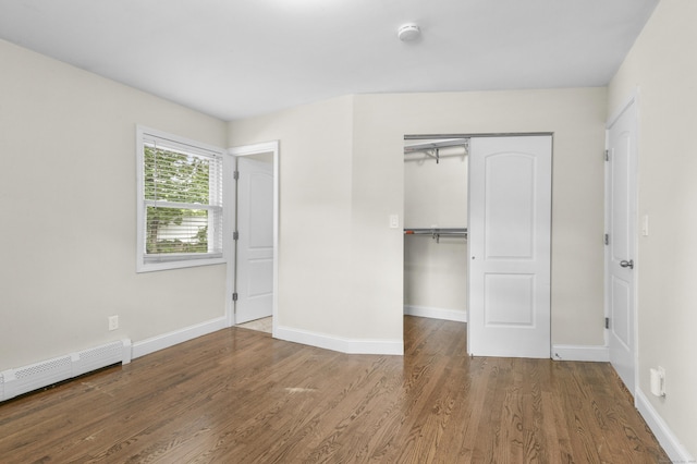 198 Macon Dr, Bridgeport, CT 06606 - unfurnished bedroom featuring a baseboard heating unit, wood finished floors, and a closet