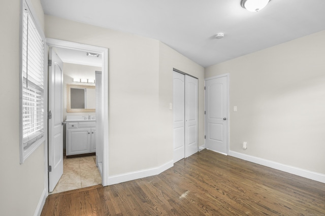 198 Macon Dr, Bridgeport, CT 06606 - unfurnished bedroom featuring wood finished floors, a closet, and ensuite bathroom