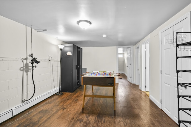 198 Macon Dr, Bridgeport, CT 06606 - rec room with a baseboard radiator and dark wood-style floors