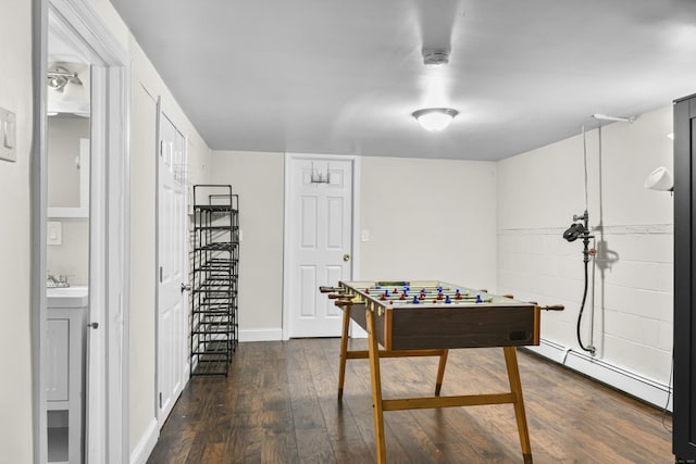 198 Macon Dr, Bridgeport, CT 06606 - playroom featuring baseboard heating and dark wood finished floors
