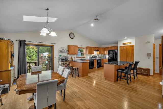 41 Fog Plain Rd, Waterford, CT 06385 - dining area with a skylight, light wood-style flooring, a chandelier, and high vaulted ceiling