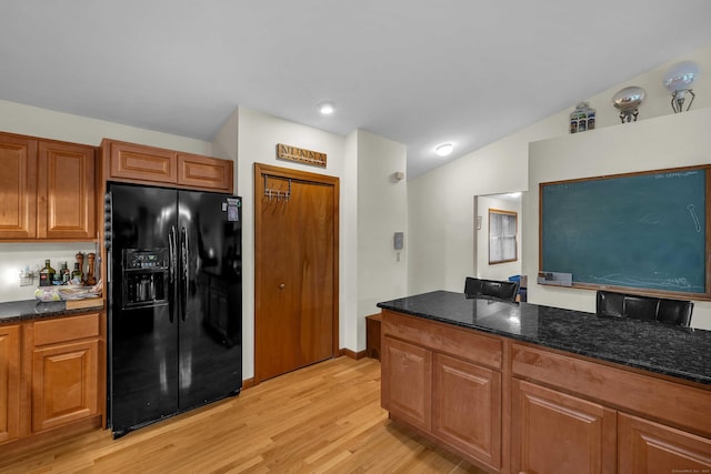 41 Fog Plain Rd, Waterford, CT 06385 - kitchen featuring black fridge, light wood-style flooring, dark stone counters, brown cabinets, and lofted ceiling