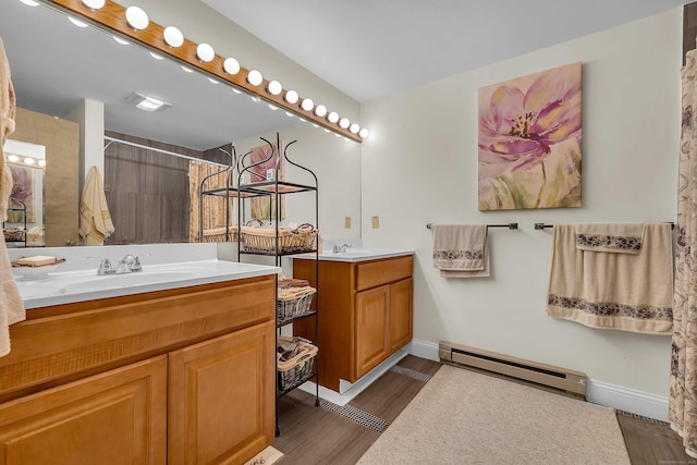 41 Fog Plain Rd, Waterford, CT 06385 - bathroom with baseboard heating, two vanities, wood finished floors, and a shower with shower curtain
