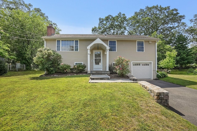 76 Valley View Rd, Norwalk, CT 06851 - bi-level home with a chimney, asphalt driveway, an attached garage, and a front yard