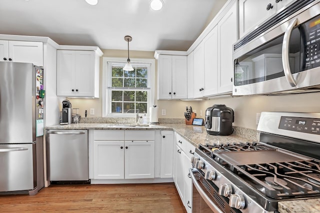 76 Valley View Rd, Norwalk, CT 06851 - kitchen with stainless steel appliances, white cabinetry, and light wood-style flooring