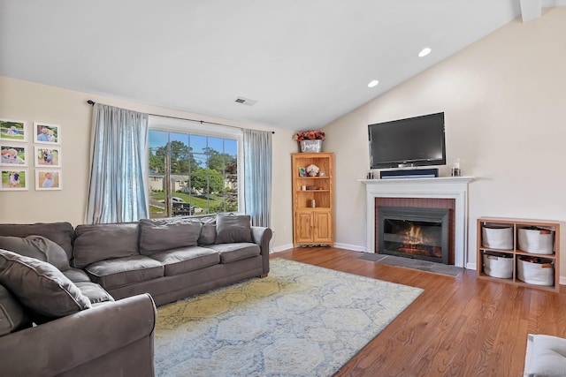 76 Valley View Rd, Norwalk, CT 06851 - living area featuring vaulted ceiling, wood finished floors, a fireplace, and recessed lighting