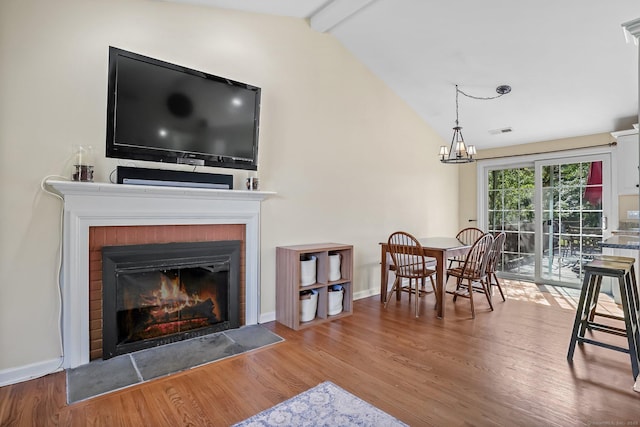 76 Valley View Rd, Norwalk, CT 06851 - living room with wood finished floors, a fireplace, and a chandelier