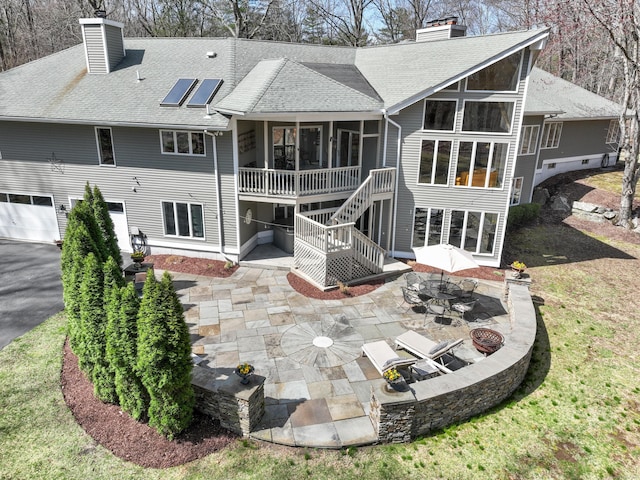 80 Norton Rd, Easton, CT 06612 - back of property featuring a chimney, a sunroom, a patio area, and roof with shingles