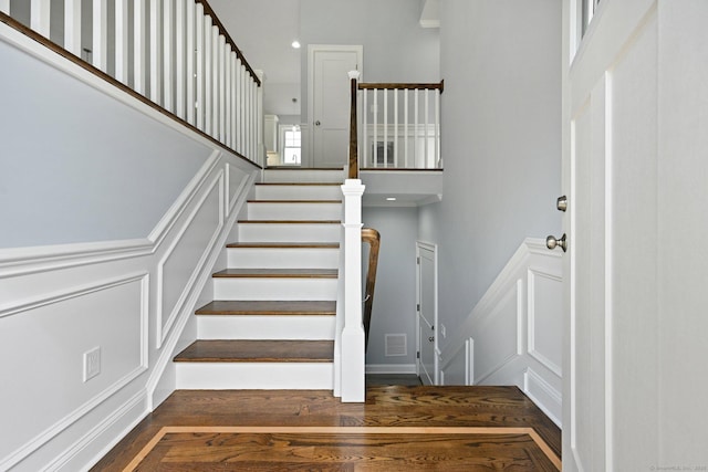 01 Sunrise Rd, Danbury, CT 06811 - stairs featuring a decorative wall, wood finished floors, and a wainscoted wall