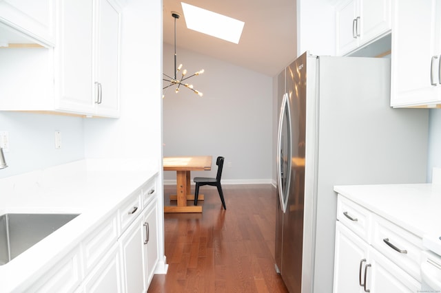 234 Greens Farm Rd Unit 234, Branford, CT 06405 - kitchen featuring a skylight, freestanding refrigerator, a chandelier, dark wood-style flooring, and white cabinetry