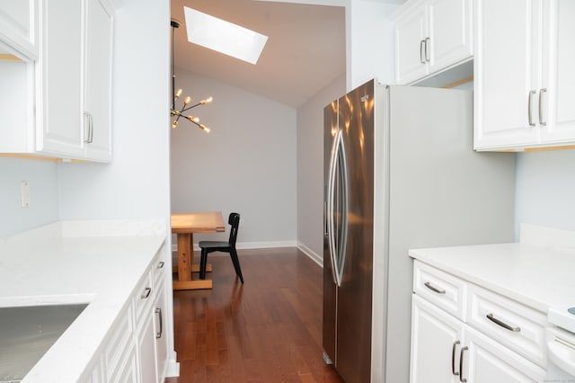 234 Greens Farm Rd Unit 234, Branford, CT 06405 - kitchen featuring a skylight, a chandelier, vaulted ceiling, dark wood-type flooring, and white cabinetry