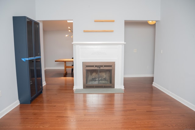 234 Greens Farm Rd Unit 234, Branford, CT 06405 - unfurnished living room with a fireplace with flush hearth, wood finished floors, and a chandelier