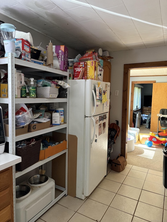 74 Pine Rd, East Haddam, CT 06423 - kitchen with freestanding refrigerator, light tile patterned flooring, light countertops, and brown cabinets