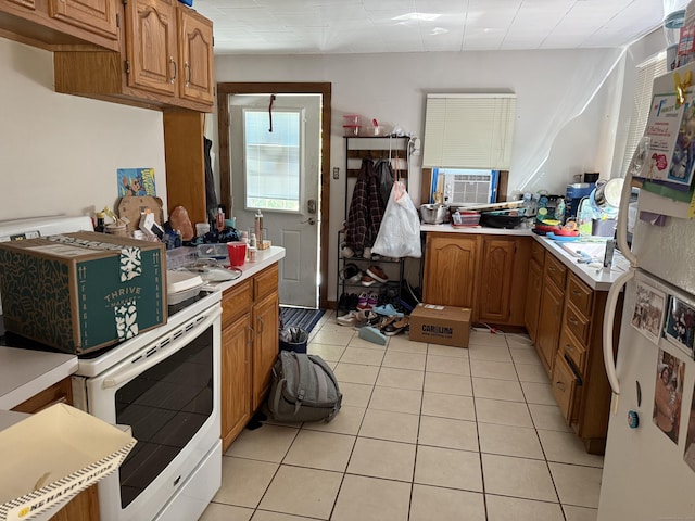 74 Pine Rd, East Haddam, CT 06423 - kitchen featuring white appliances, cooling unit, light countertops, light tile patterned floors, and brown cabinets