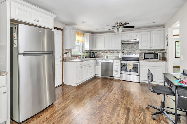 474 Franklin Ave, Stratford, CT 06614 - kitchen with appliances with stainless steel finishes, under cabinet range hood, a ceiling fan, dark wood-style floors, and decorative backsplash