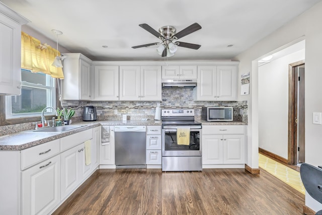 474 Franklin Ave, Stratford, CT 06614 - kitchen with stainless steel appliances, under cabinet range hood, white cabinetry, tasteful backsplash, and a ceiling fan
