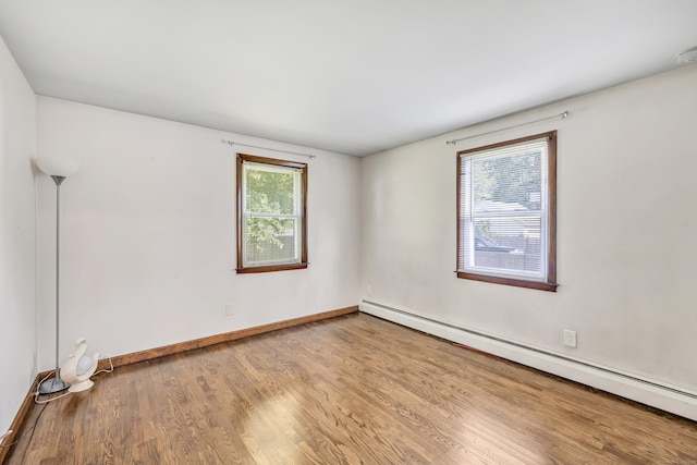 474 Franklin Ave, Stratford, CT 06614 - empty room featuring a baseboard heating unit, wood finished floors, and a smoke detector