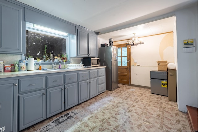 370 Waterville St, Waterbury, CT 06710 - kitchen featuring appliances with stainless steel finishes, a chandelier, gray cabinetry, and light countertops
