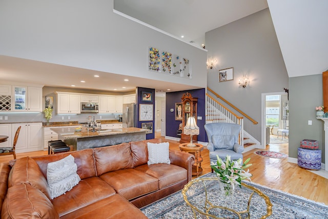 10 Harmony Trl Unit 10, New Milford, CT 06776 - living area featuring high vaulted ceiling, stairway, light wood-type flooring, and recessed lighting