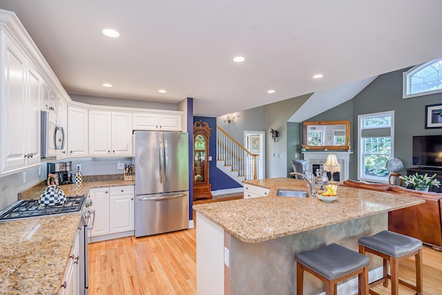 10 Harmony Trl Unit 10, New Milford, CT 06776 - kitchen featuring stainless steel appliances, light wood-type flooring, white cabinetry, a kitchen bar, and recessed lighting