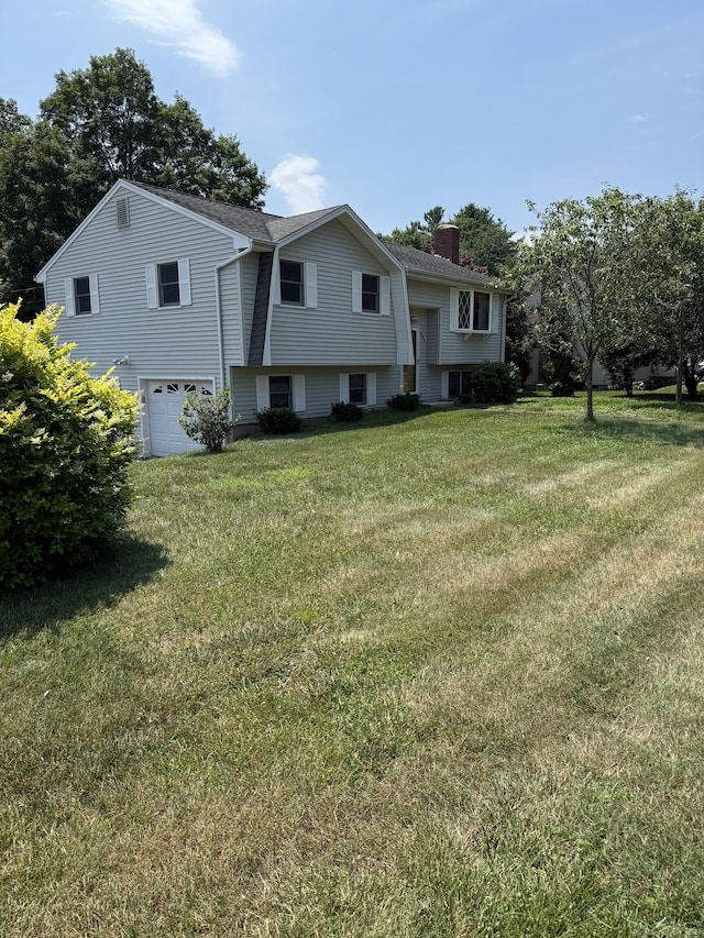 109 Ashley Rd, Bristol, CT 06010 - split foyer home with a chimney, an attached garage, and a front yard