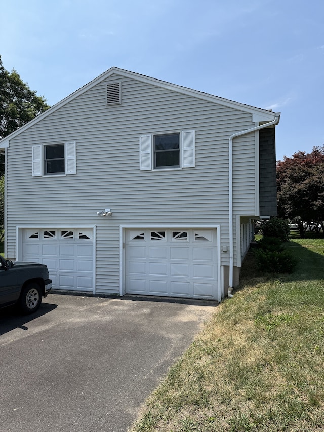 109 Ashley Rd, Bristol, CT 06010 - view of property exterior with an attached garage, driveway, and a lawn