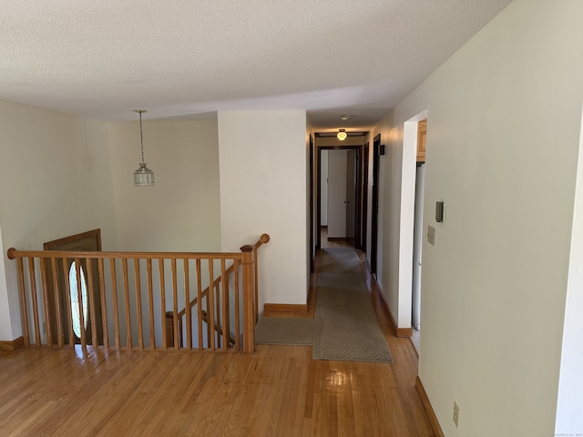 109 Ashley Rd, Bristol, CT 06010 - corridor featuring an upstairs landing, light wood finished floors, and a textured ceiling