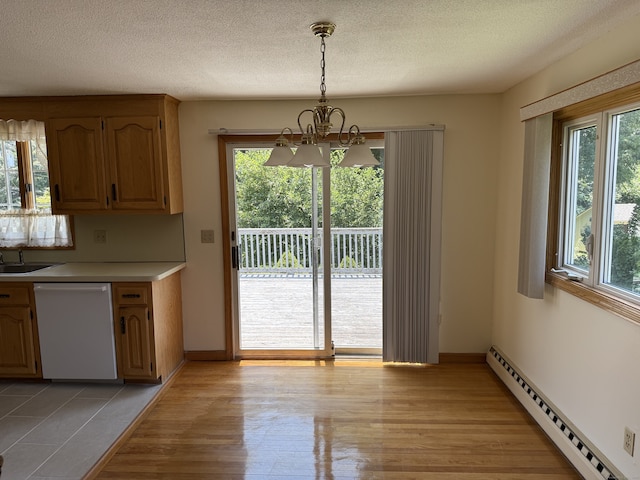 109 Ashley Rd, Bristol, CT 06010 - kitchen featuring white dishwasher, a baseboard radiator, a chandelier, light countertops, and light wood-style floors