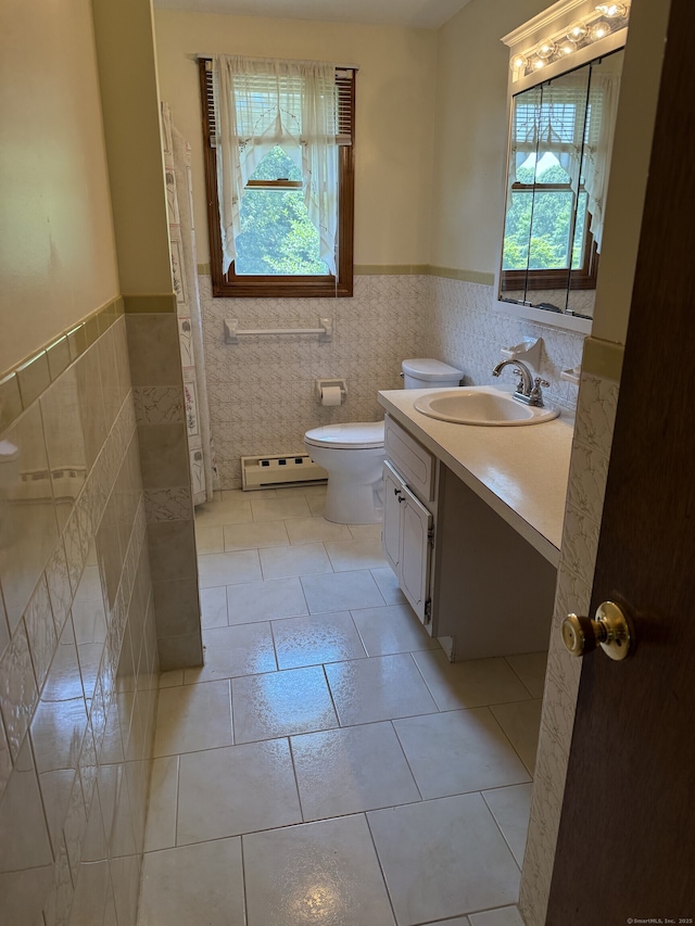 109 Ashley Rd, Bristol, CT 06010 - bathroom featuring baseboard heating, tile walls, vanity, wainscoting, and tile patterned floors