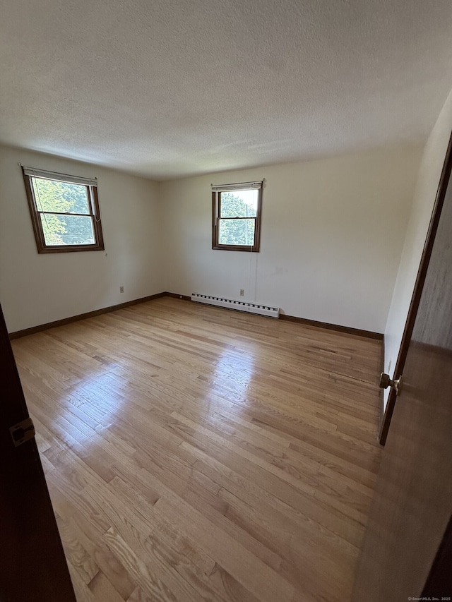 109 Ashley Rd, Bristol, CT 06010 - spare room with baseboard heating, light wood finished floors, and a textured ceiling
