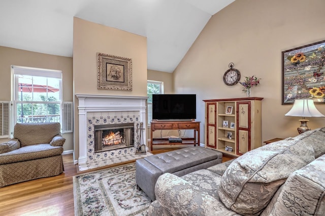 11 Parlor Rock Rd, Trumbull, CT 06611 - living area with wood finished floors, plenty of natural light, vaulted ceiling, and a tile fireplace