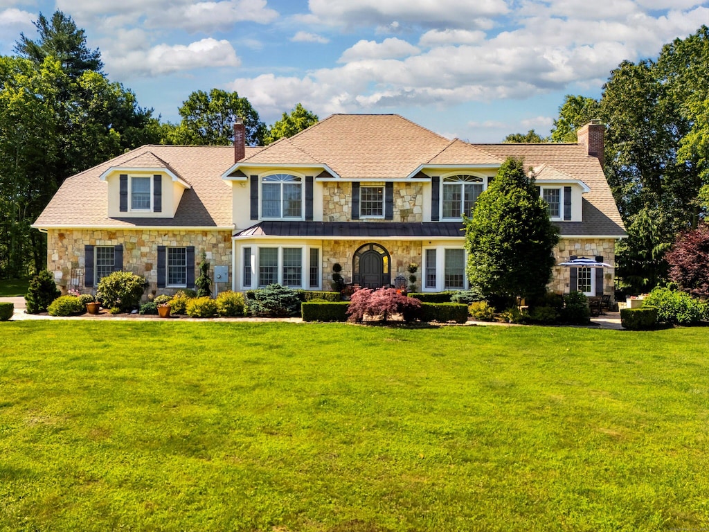 99 Carriage Ln, Roxbury, CT 06783 - view of front of house featuring stone siding, a chimney, and a front yard