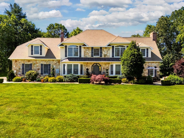 99 Carriage Ln, Roxbury, CT 06783 - view of front of house featuring stone siding, a chimney, and a front yard