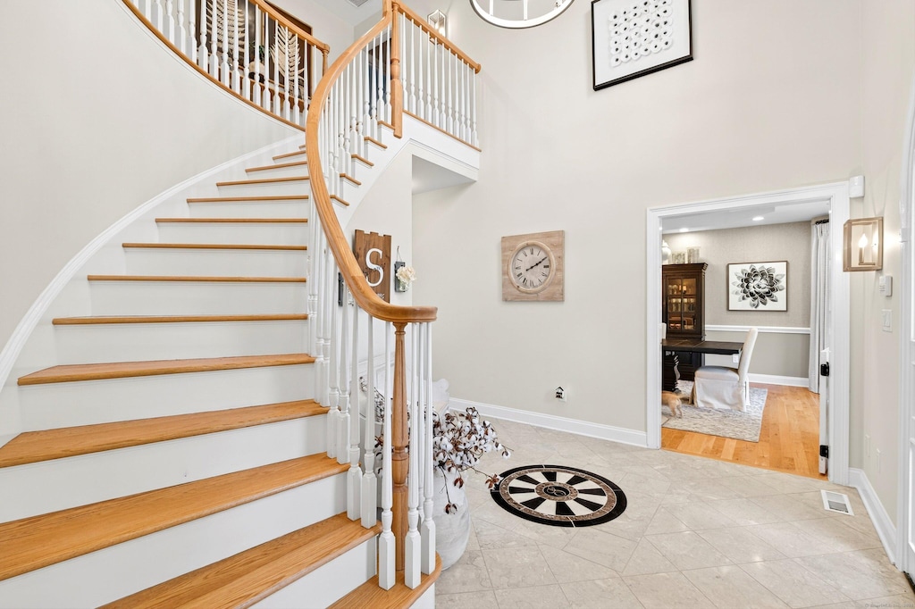 99 Carriage Ln, Roxbury, CT 06783 - stairs featuring a towering ceiling and tile patterned flooring