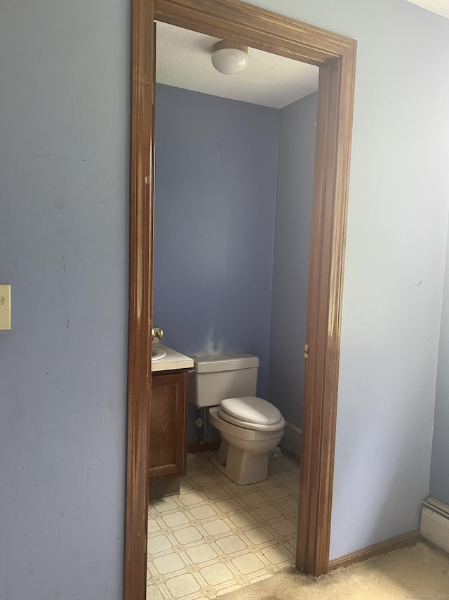 67 Harold Rd, Farmington, CT 06032 - half bath featuring vanity, a baseboard radiator, and tile patterned floors