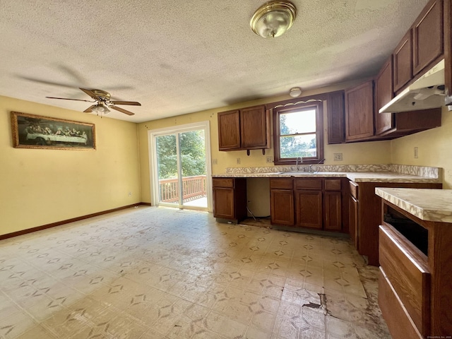 67 Harold Rd, Farmington, CT 06032 - kitchen with plenty of natural light, light countertops, ceiling fan, a textured ceiling, and under cabinet range hood