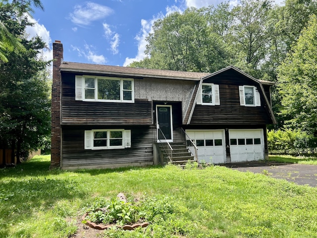 67 Harold Rd, Farmington, CT 06032 - split foyer home with a garage, asphalt driveway, a chimney, and entry steps