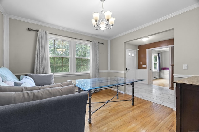 2 Judith Dr, Danbury, CT 06811 - living room featuring a chandelier, light wood-style floors, healthy amount of natural light, ornamental molding, and a baseboard heating unit