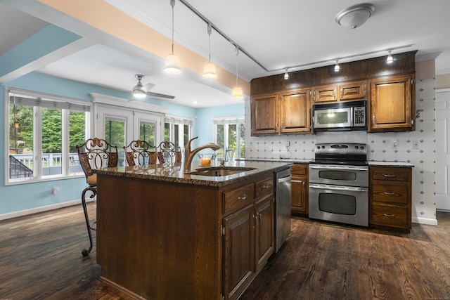 2 Judith Dr, Danbury, CT 06811 - kitchen with appliances with stainless steel finishes, track lighting, dark stone countertops, a center island with sink, and ceiling fan