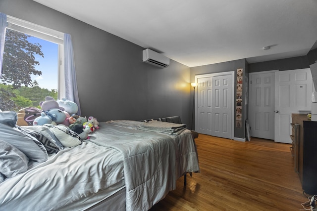 2 Judith Dr, Danbury, CT 06811 - bedroom with an AC wall unit and wood finished floors