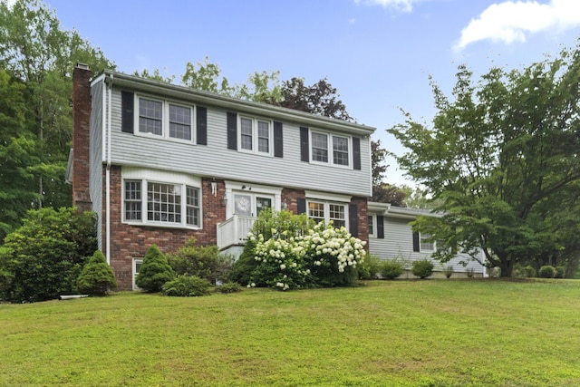 2 Judith Dr, Danbury, CT 06811 - colonial home featuring a chimney, a front yard, and brick siding