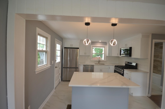 51 Grandview Ave, Norwalk, CT 06850 - kitchen featuring stainless steel appliances, light marble finish flooring, backsplash, and white cabinets
