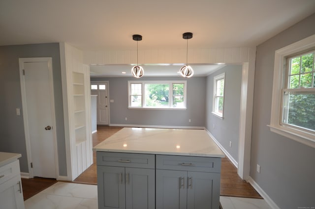 51 Grandview Ave, Norwalk, CT 06850 - kitchen with plenty of natural light, gray cabinetry, hanging light fixtures, and light stone countertops
