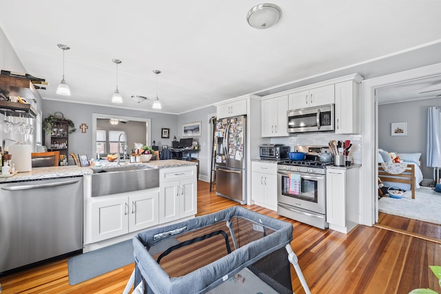 33 Hugh St, West Hartford, CT 06119 - kitchen featuring appliances with stainless steel finishes, ceiling fan, decorative light fixtures, and white cabinetry