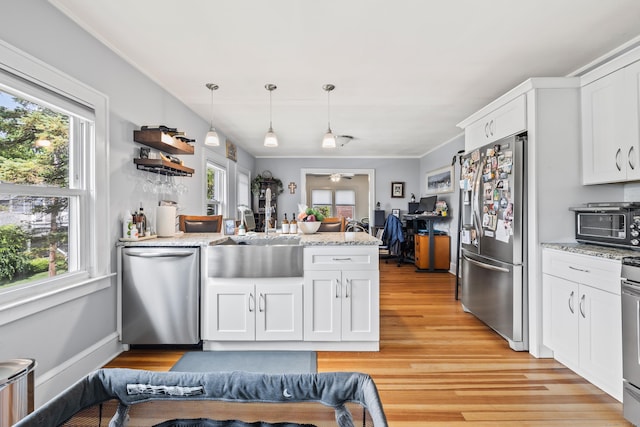 33 Hugh St, West Hartford, CT 06119 - kitchen with appliances with stainless steel finishes, a peninsula, and healthy amount of natural light