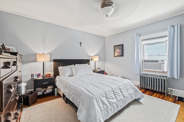 33 Hugh St, West Hartford, CT 06119 - bedroom featuring radiator, wood finished floors, cooling unit, and a ceiling fan